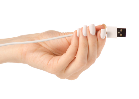 USB plug in hand on white background isolationの写真素材