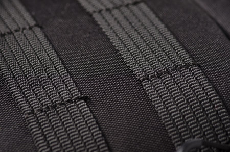 fastening slings malle on a black backpack macro