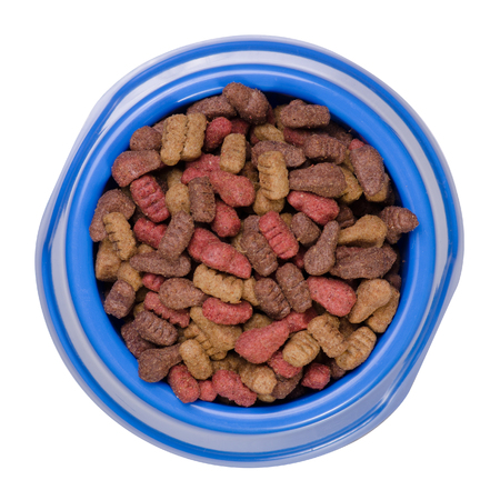 Dry food in a bowl for dogs and cats on a white background isolation, top viewの写真素材