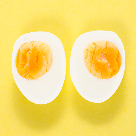 Boiled egg on a yellow background isolationの写真素材