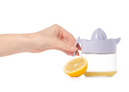 Juicer lemon juice in hands on white background isolationの写真素材
