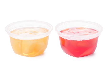 Cup of jelly with fruit red peach yellow pineapple on white background isolation isolationの写真素材
