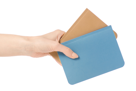 Two diary notebook in hand on white background isolationの写真素材