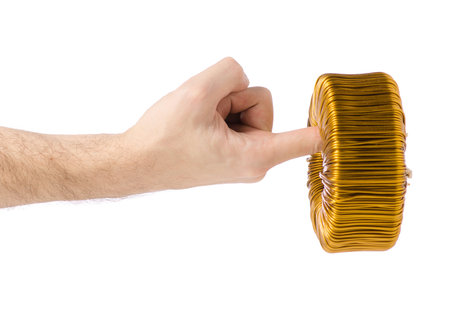 Transformer coil in hand on white background isolation