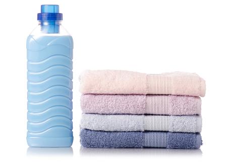 A stack of towels softener conditioner liquid laundry detergent on white background isolationの写真素材