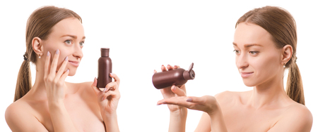 Beautiful young woman beauty bottle face with cosmetics for body and face oil lotion set on white background isolationの写真素材