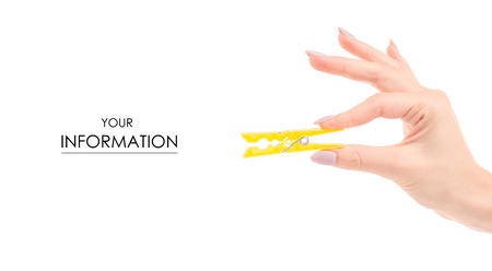 Clothespin in female hands pattern on white background isolationの写真素材