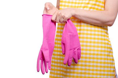 Woman in apron in hands cleaning gloves on white background isolationの写真素材