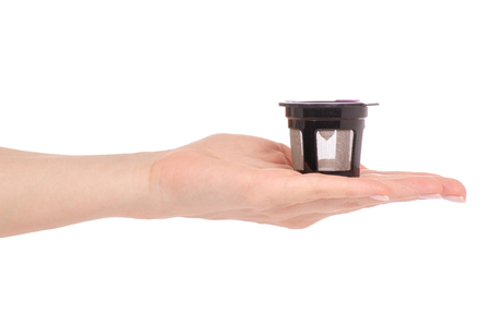 Capsule for coffee machine in hand on white background isolationの写真素材