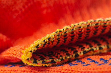 Orange working building gloves cloth macro blurred backgroundの写真素材