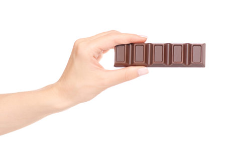 A bar of chocolate in hand on white background isolationの写真素材