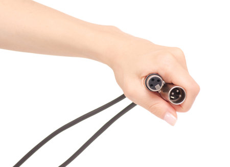 Xlr cable in hand sound microphone electronic on white background isolationの写真素材