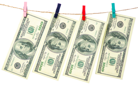 Money dollars clothespins rope on white background isolationの写真素材