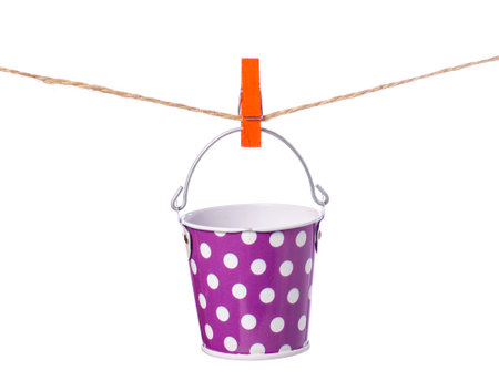 A bucket of clothespins rope on a white background isolationの写真素材