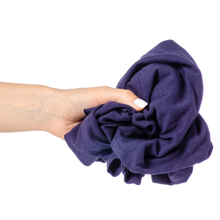 Crumpled blue T-shirt in hand clothes fabric on white background isolationの写真素材