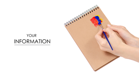 Notepad for drawing and paint brush in hand pattern on white background isolationの写真素材