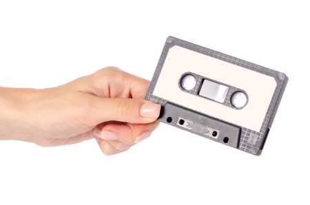 Audio cassette in hand stereo music on white background isolationの写真素材