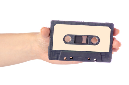 Audio cassette in hand stereo music on white background isolationの写真素材