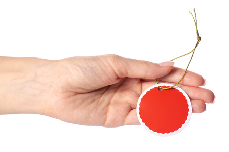 Cardboard circle on a rope tag in hand on a white background isolationの写真素材