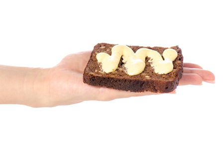 Piece of bread with sauce mayonnaise in hand on white background isolationの写真素材
