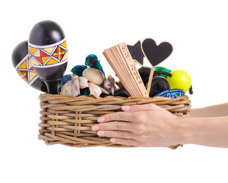 A basket with a decor for a house in hand on a white background isolationの写真素材