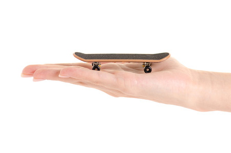 Skateboard toy in hand on a white background isolationの写真素材