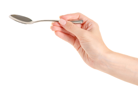 Tea spoon in a hand on a white background isolationの写真素材
