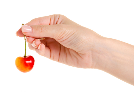 Cherries in hand on a white background isolationの写真素材