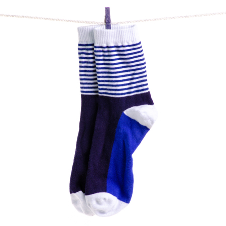 Socks on a rope clothespins on a white background isolationの写真素材