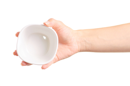 White bowl empty in hand on a white background isolationの写真素材