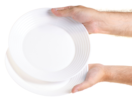 Two plates white in a hand on a white background isolationの写真素材