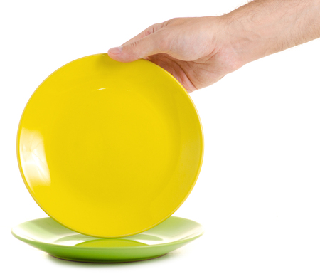 Two plates colorful in a hand on a white background isolationの写真素材