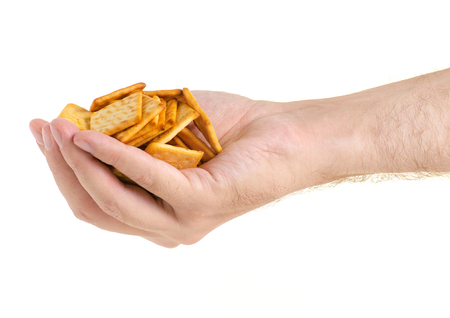 Cracker in hand on white background isolationの写真素材