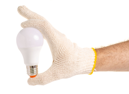 LED lamp in a hand on a white background isolationの写真素材