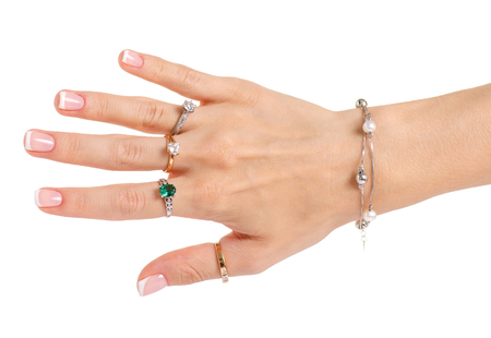 Female hand in rings bracelet on white background isolationの写真素材