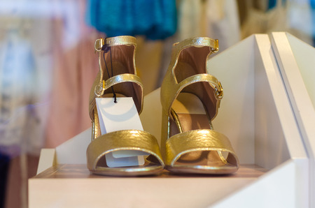 Woman's female sandals shoes in shop on the stand storefrontの写真素材