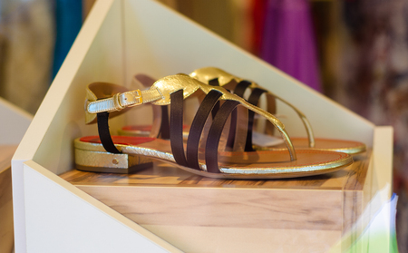 Woman's female sandals in shop on the stand storefrontの写真素材