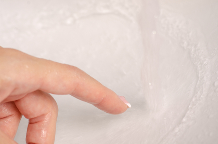 Water in the washbasin bathroom female hand clean washの写真素材