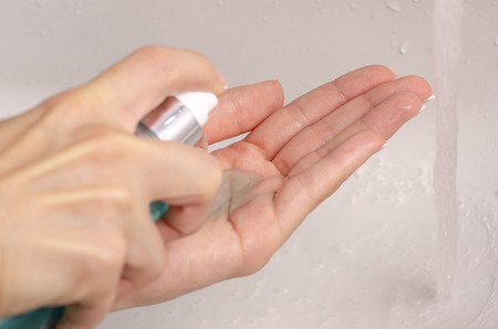 Water in the washbasin female hand face gel bathroom clean washの写真素材