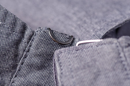 Gray fabric cloth fittings macro clothing on blur background