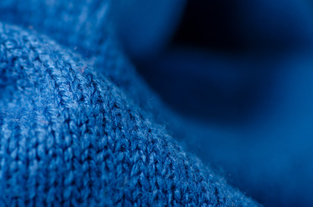 Blue fabric pullover clothing texture on blur backgroundの写真素材