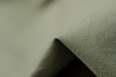Green military cloth macro fittings clothing on blur backgroundの写真素材