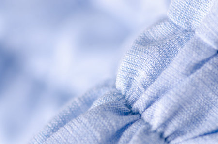 Blue fabric linen clothing seams rubber band on blur background