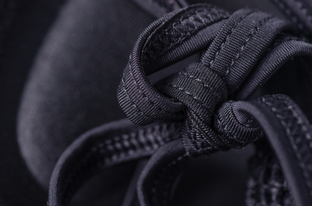 Black swimsuit bra push up seams of a string laces macro backgroundの写真素材