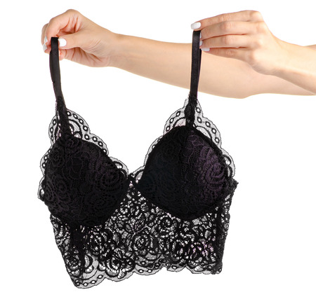The black lace bra lace in hand on white background isolationの写真素材