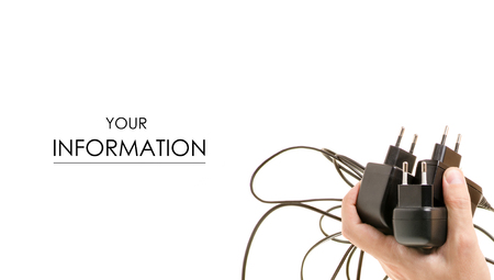 Old chargers on phones in male hands pattern on white background isolationの写真素材