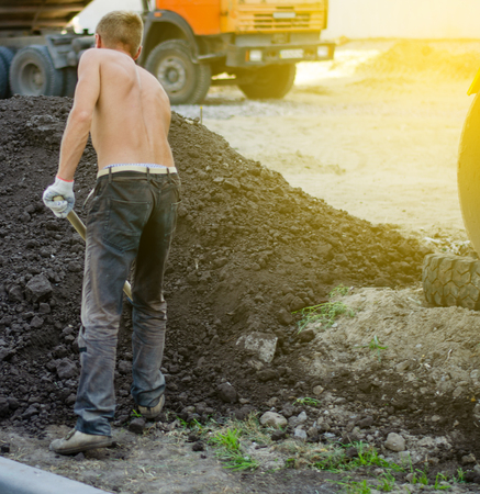 Man with a shovel construction building worker man builder street sunの写真素材