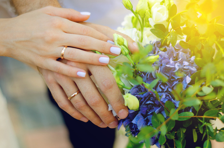 Bride groom flowers bouquet hands rings married sunの写真素材