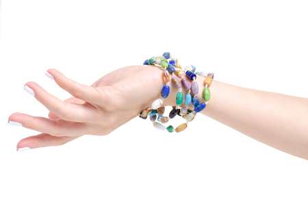 Beads colorful stones bracelet in hand on a white background isolationの写真素材