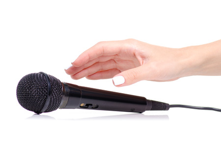 Microphone in hand on white background isolationの写真素材